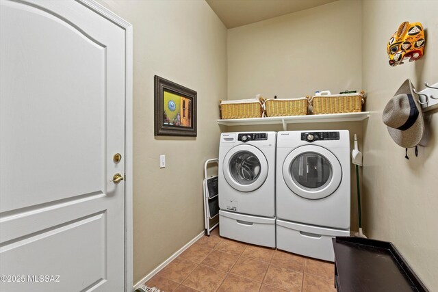 clothes washing area featuring washing machine and dryer and light tile patterned floors