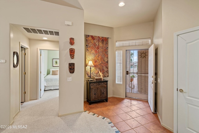 view of carpeted foyer