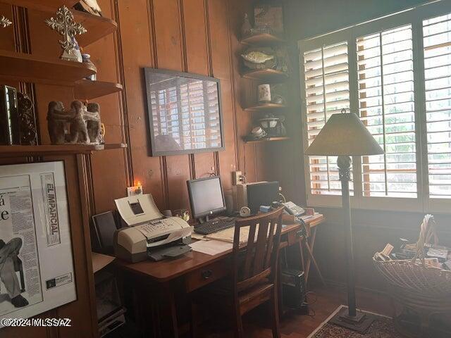 home office with wood walls