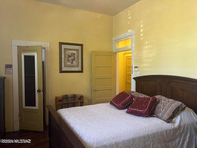 bedroom with dark hardwood / wood-style floors