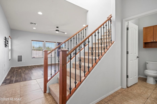 staircase featuring ceiling fan and tile patterned floors