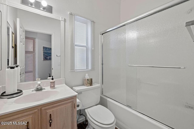 full bathroom with shower / bath combination with glass door, vanity, and toilet