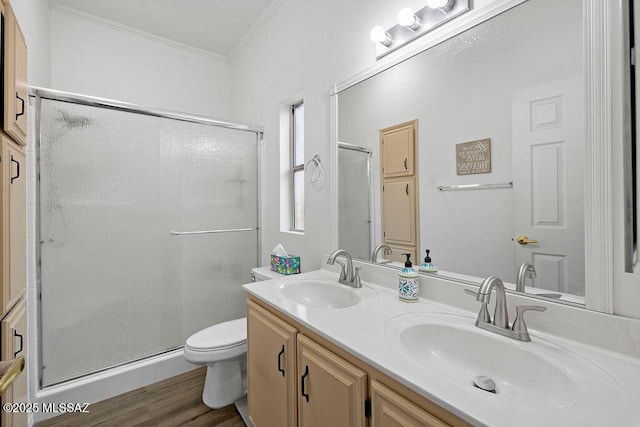 bathroom with vanity, toilet, ornamental molding, walk in shower, and wood-type flooring