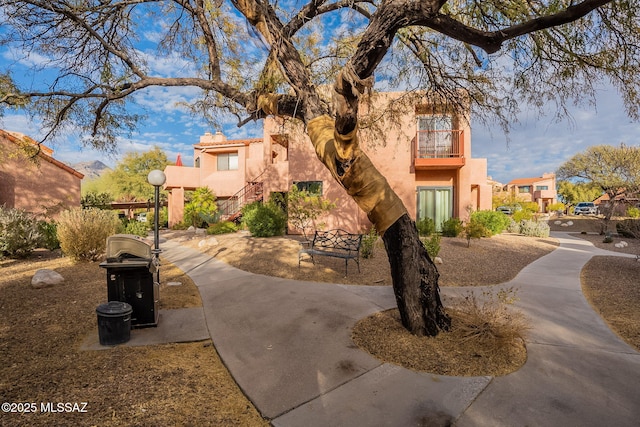 adobe home featuring a balcony