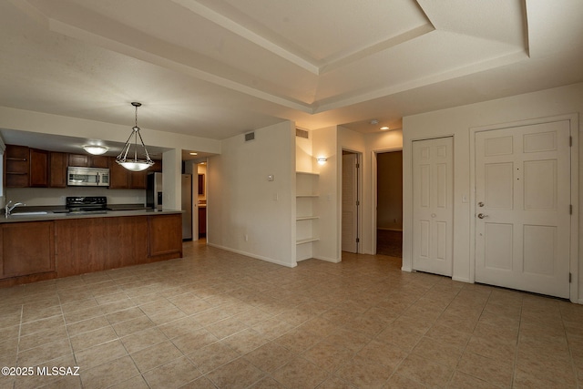 kitchen featuring sink, hanging light fixtures, stainless steel appliances, a raised ceiling, and kitchen peninsula