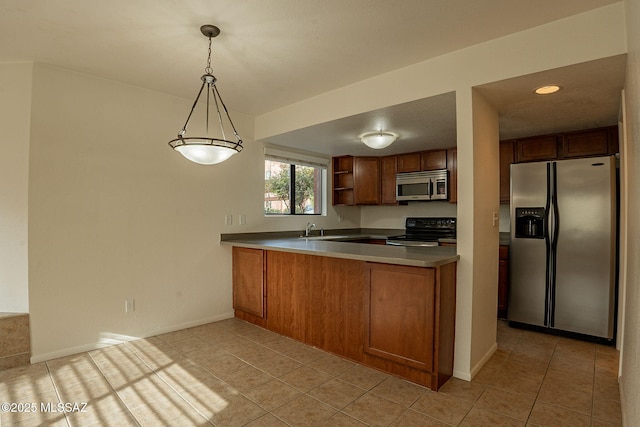 kitchen with kitchen peninsula, hanging light fixtures, light tile patterned floors, and stainless steel appliances