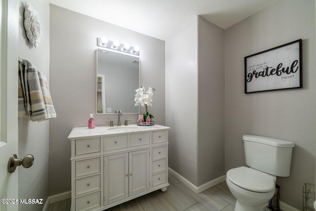 bathroom featuring toilet and vanity