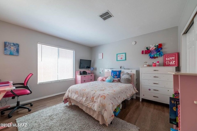 bedroom featuring a closet and dark hardwood / wood-style floors