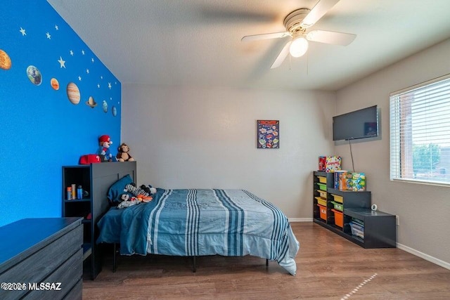 bedroom with ceiling fan and hardwood / wood-style flooring