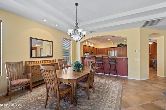 dining space featuring ceiling fan with notable chandelier