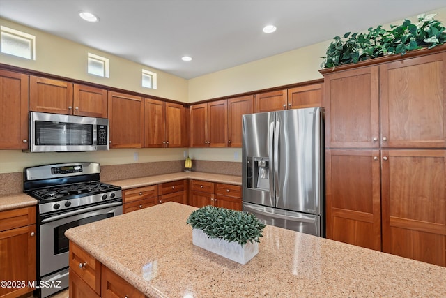 kitchen featuring light stone counters and stainless steel appliances