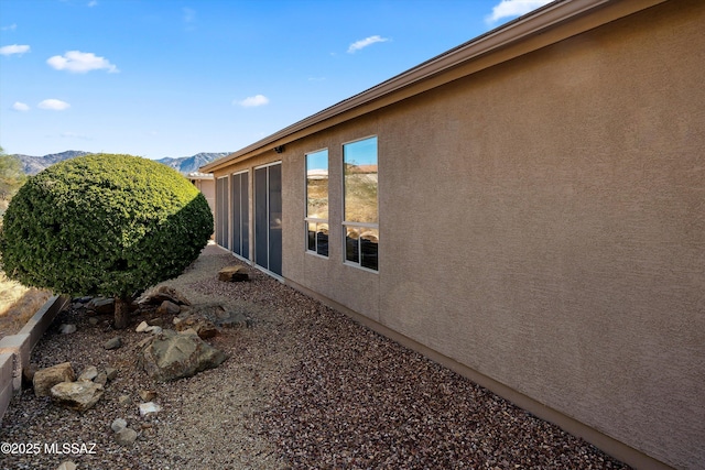 view of side of property with a mountain view