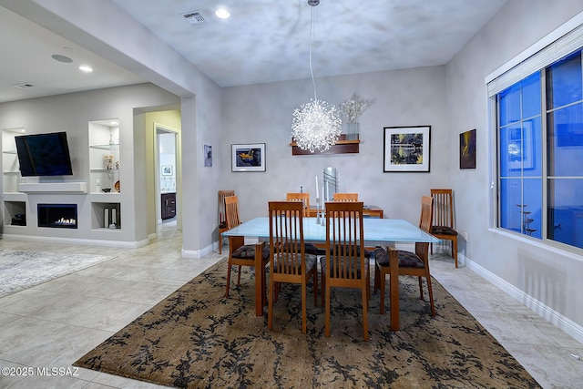 tiled dining space with a chandelier and built in features