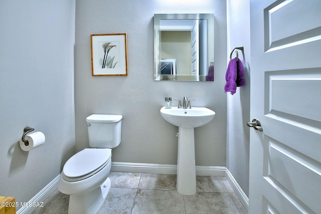 bathroom with tile patterned floors and toilet