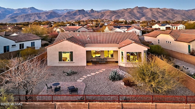 rear view of property with a mountain view and a patio area