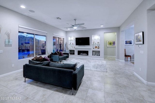 living room featuring ceiling fan, built in features, and light tile patterned floors