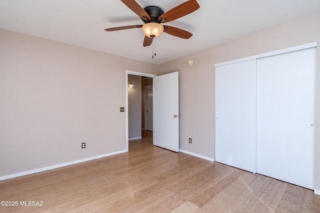 unfurnished bedroom featuring a closet, ceiling fan, and light wood-type flooring