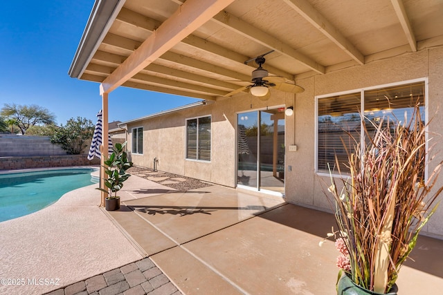 view of patio / terrace with ceiling fan and a fenced in pool