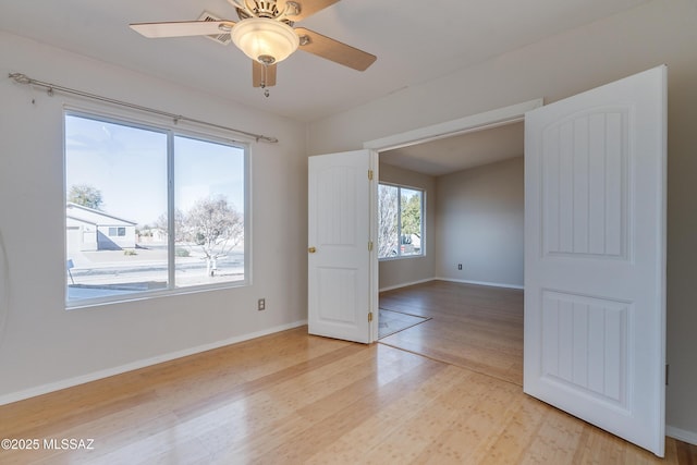 spare room featuring ceiling fan and light hardwood / wood-style floors