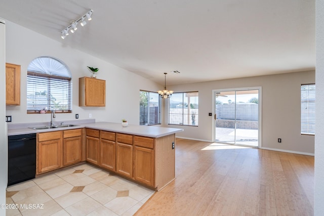 kitchen with kitchen peninsula, dishwasher, hanging light fixtures, track lighting, and sink