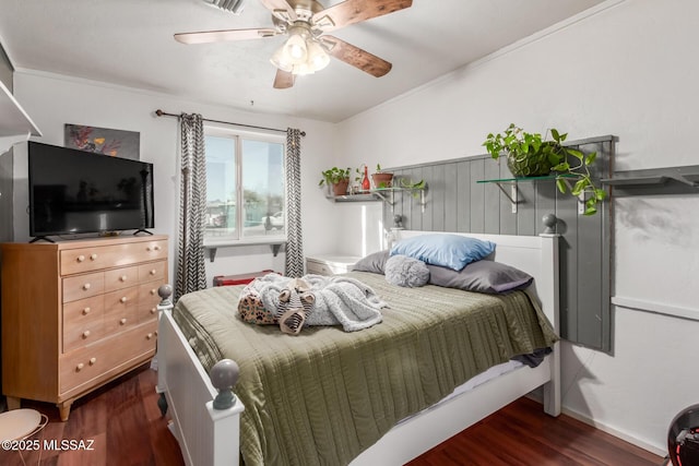 bedroom with dark wood-type flooring, ceiling fan, and ornamental molding