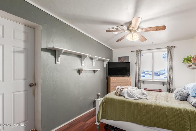 bedroom with dark wood-type flooring, ceiling fan, and vaulted ceiling