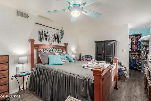 bedroom with ceiling fan, a closet, and dark wood-type flooring