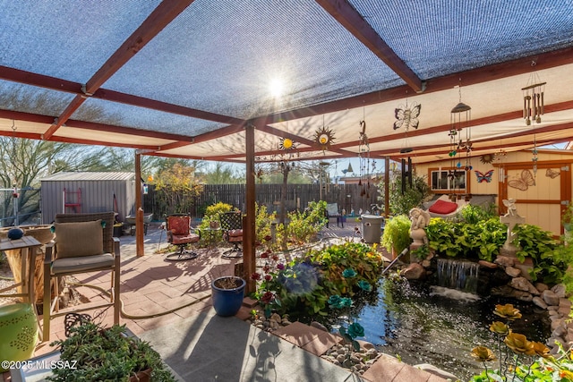 view of patio / terrace with a shed and a pergola