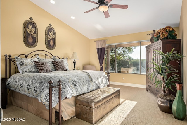 carpeted bedroom with ceiling fan and vaulted ceiling