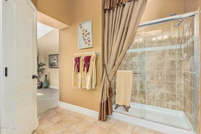 bathroom featuring tile patterned floors and a shower with door