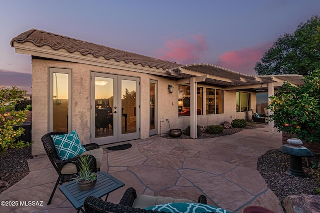 patio terrace at dusk with french doors and a pergola