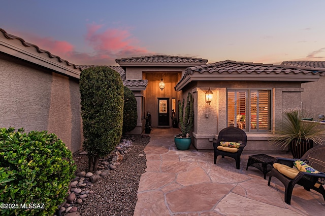 view of patio terrace at dusk