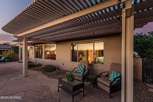 patio terrace at dusk featuring a pergola