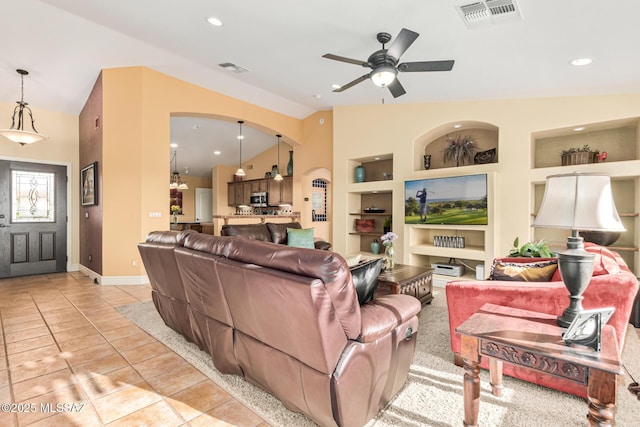 tiled living room featuring built in features, ceiling fan, and lofted ceiling