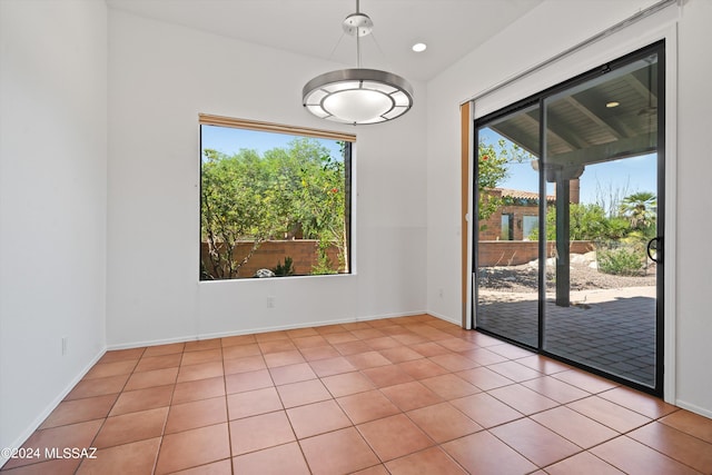 unfurnished dining area with light tile patterned flooring