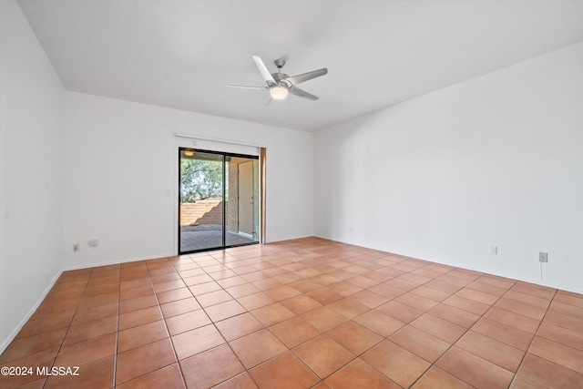 spare room with ceiling fan and light tile patterned flooring