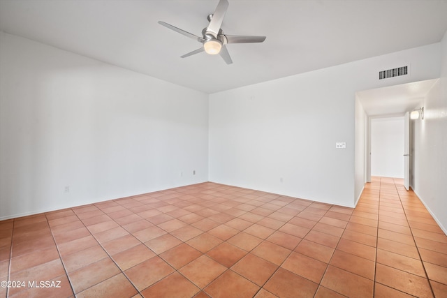 spare room featuring ceiling fan and light tile patterned floors