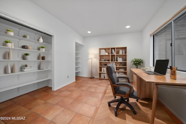 office area with light tile patterned floors and built in features