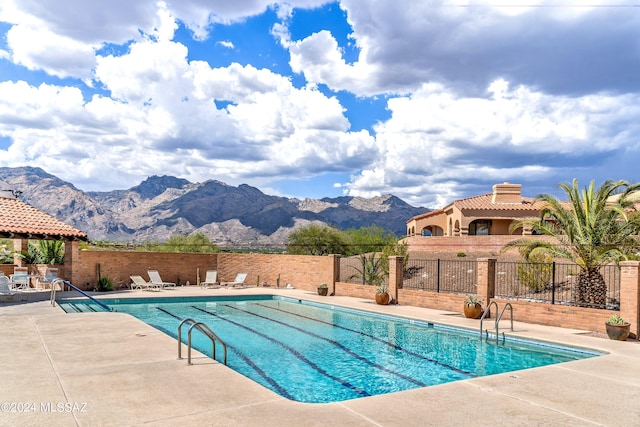 view of pool with a mountain view and a patio