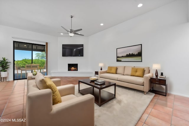 living room with ceiling fan and light tile patterned flooring