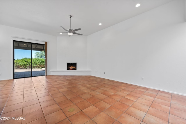 unfurnished living room featuring ceiling fan and light tile patterned floors