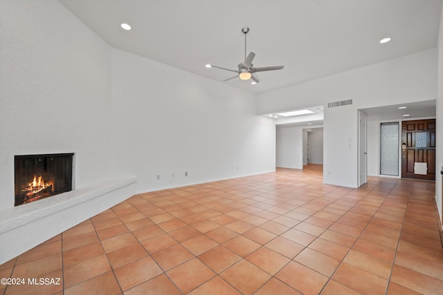 unfurnished living room with light tile patterned floors and ceiling fan