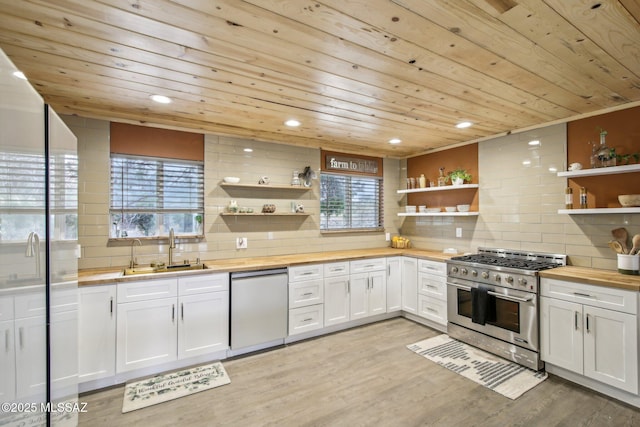 kitchen featuring dishwasher, wooden counters, high end stainless steel range, and open shelves