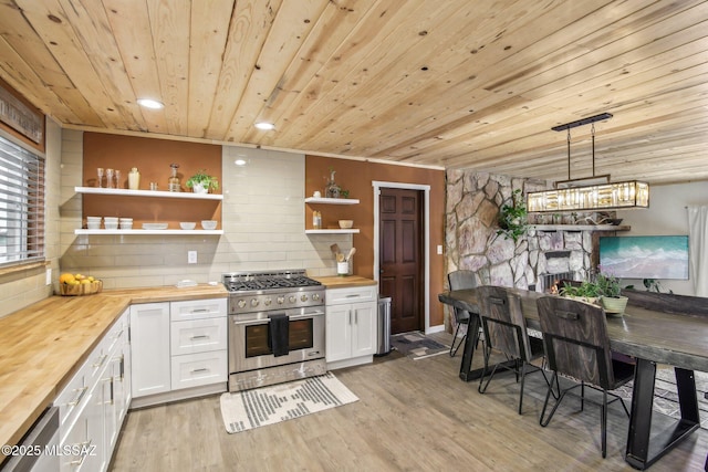 kitchen featuring light wood finished floors, open shelves, tasteful backsplash, stainless steel stove, and wood counters