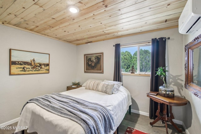 bedroom with an AC wall unit, wooden ceiling, baseboards, and wood finished floors