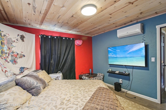 bedroom with a wall unit AC, wood finished floors, wooden ceiling, and baseboards