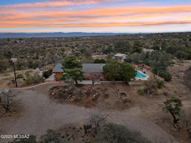 aerial view at dusk featuring a mountain view