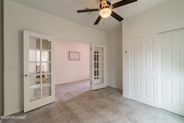 empty room with french doors and ceiling fan