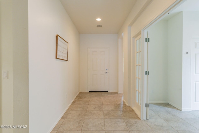 hall featuring light tile patterned floors