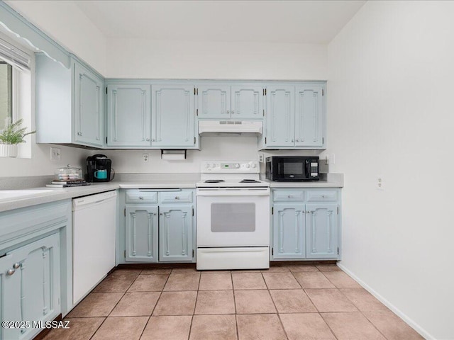 kitchen with white appliances, blue cabinets, and light tile patterned floors